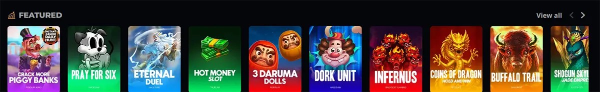 Featured slot games section with colorful thumbnails including Crack More Piggy Banks, Pray for Six, Eternal Duel, Hot Money, 3 Daruma Dolls, Dork Unit, Infernus, Coins of Dragon, Buffalo Trail, and Shogun Sky, plus a “View all” link on a dark casino interface.